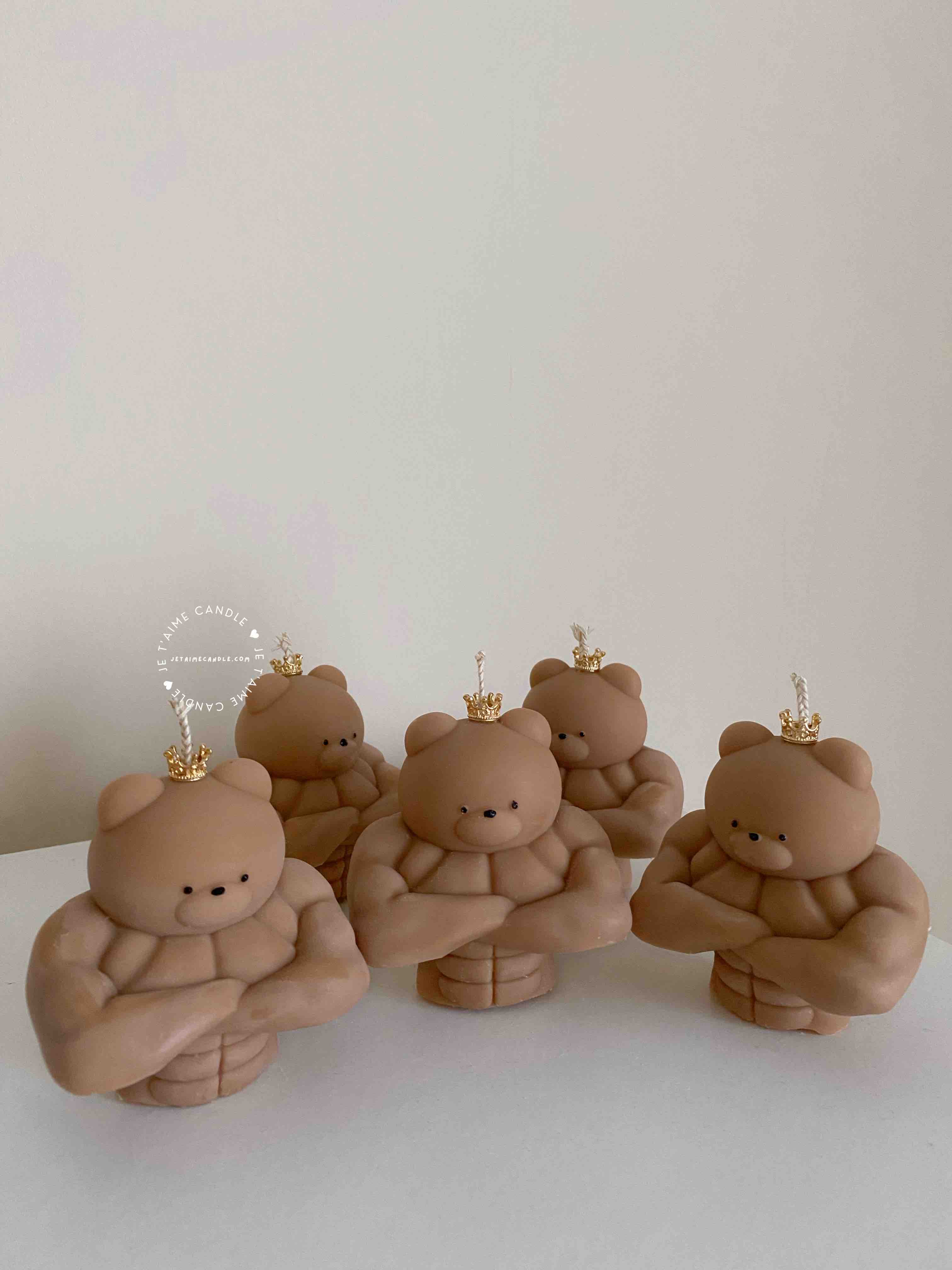 A delightful mix of small, colorful candles, showcasing the unique Buff Bear Candle, great for gifts and adding warmth to any space.
