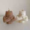 A delightful mix of small, colorful candles, showcasing the unique Buff Bear Candle, great for gifts and adding warmth to any space.