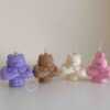 A delightful mix of small, colorful candles, showcasing the unique Buff Bear Candle, great for gifts and adding warmth to any space.