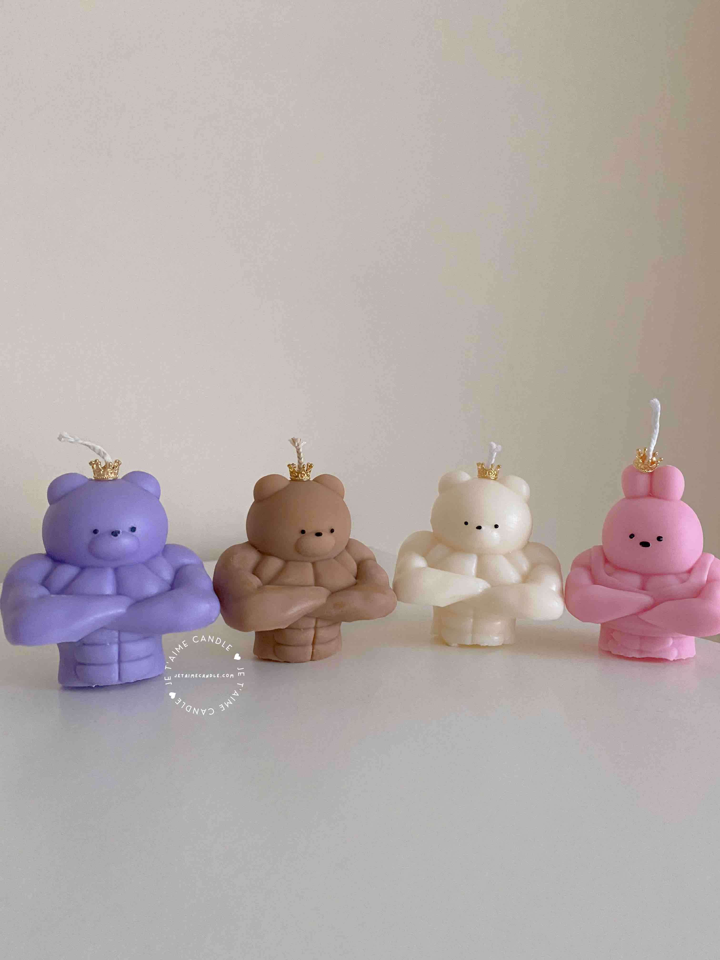 A delightful mix of small, colorful candles, showcasing the unique Buff Bear Candle, great for gifts and adding warmth to any space.