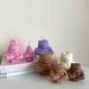 A delightful mix of small, colorful candles, showcasing the unique Buff Bear Candle, great for gifts and adding warmth to any space.