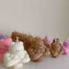 A delightful mix of small, colorful candles, showcasing the unique Buff Bear Candle, great for gifts and adding warmth to any space.