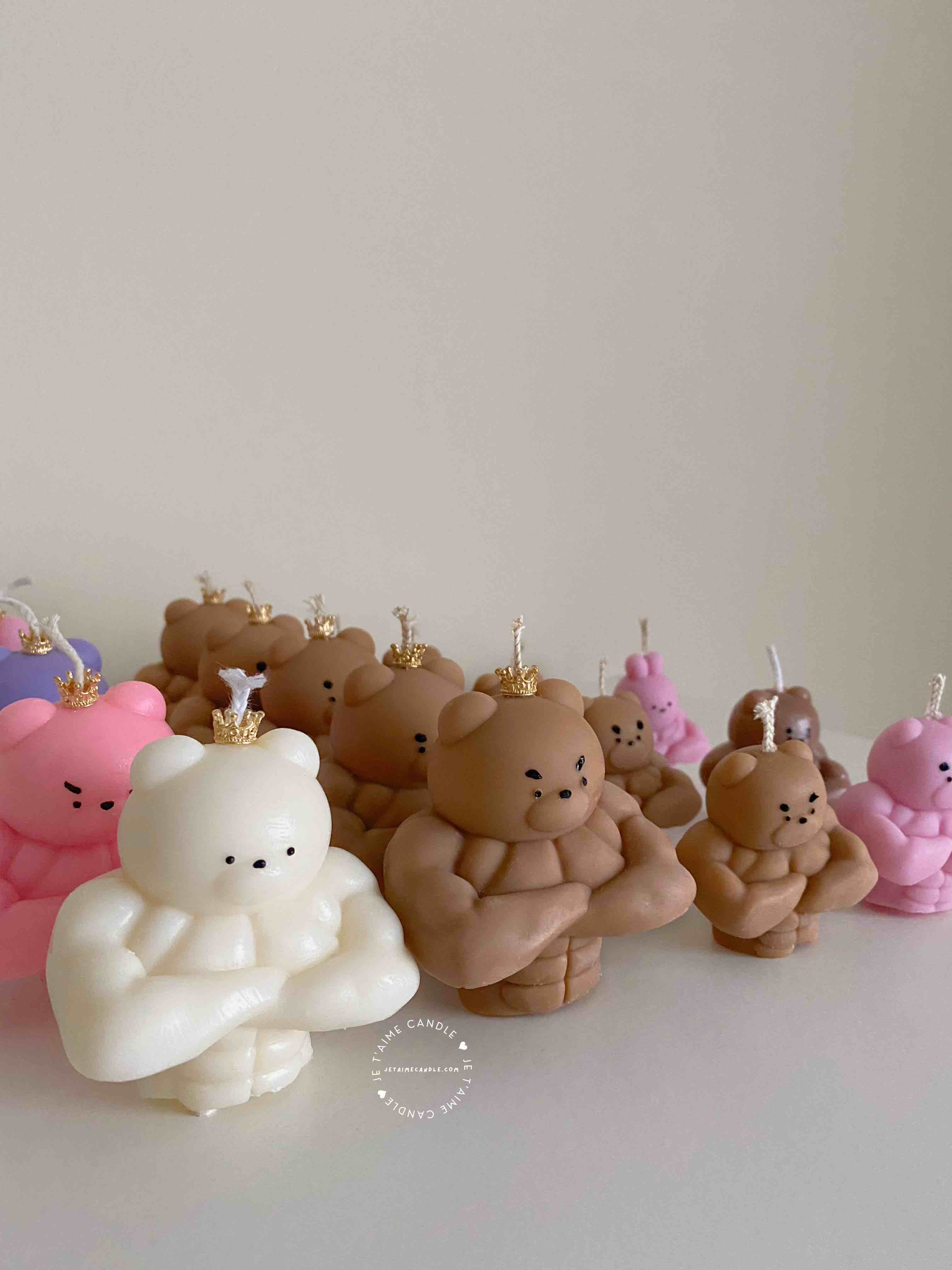 A delightful mix of small, colorful candles, showcasing the unique Buff Bear Candle, great for gifts and adding warmth to any space.