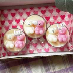 A tray adorned with teddy bears, displaying charming tea light candles to enhance any space warmth.