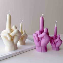 A row of multicolored candles shaped like hands making a gesture, lined up against a plain backdrop.
