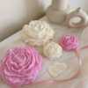 A table adorned with pink and white roses, creating a serene and elegant atmosphere for any occasion.