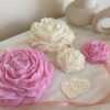 A table adorned with pink and white roses, creating a serene and elegant atmosphere for any occasion.