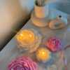 A table adorned with pink and white roses, creating a serene and elegant atmosphere for any occasion.