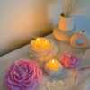 A table adorned with pink and white roses, creating a serene and elegant atmosphere for any occasion.