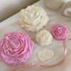 A table adorned with pink and white roses, creating a serene and elegant atmosphere for any occasion.