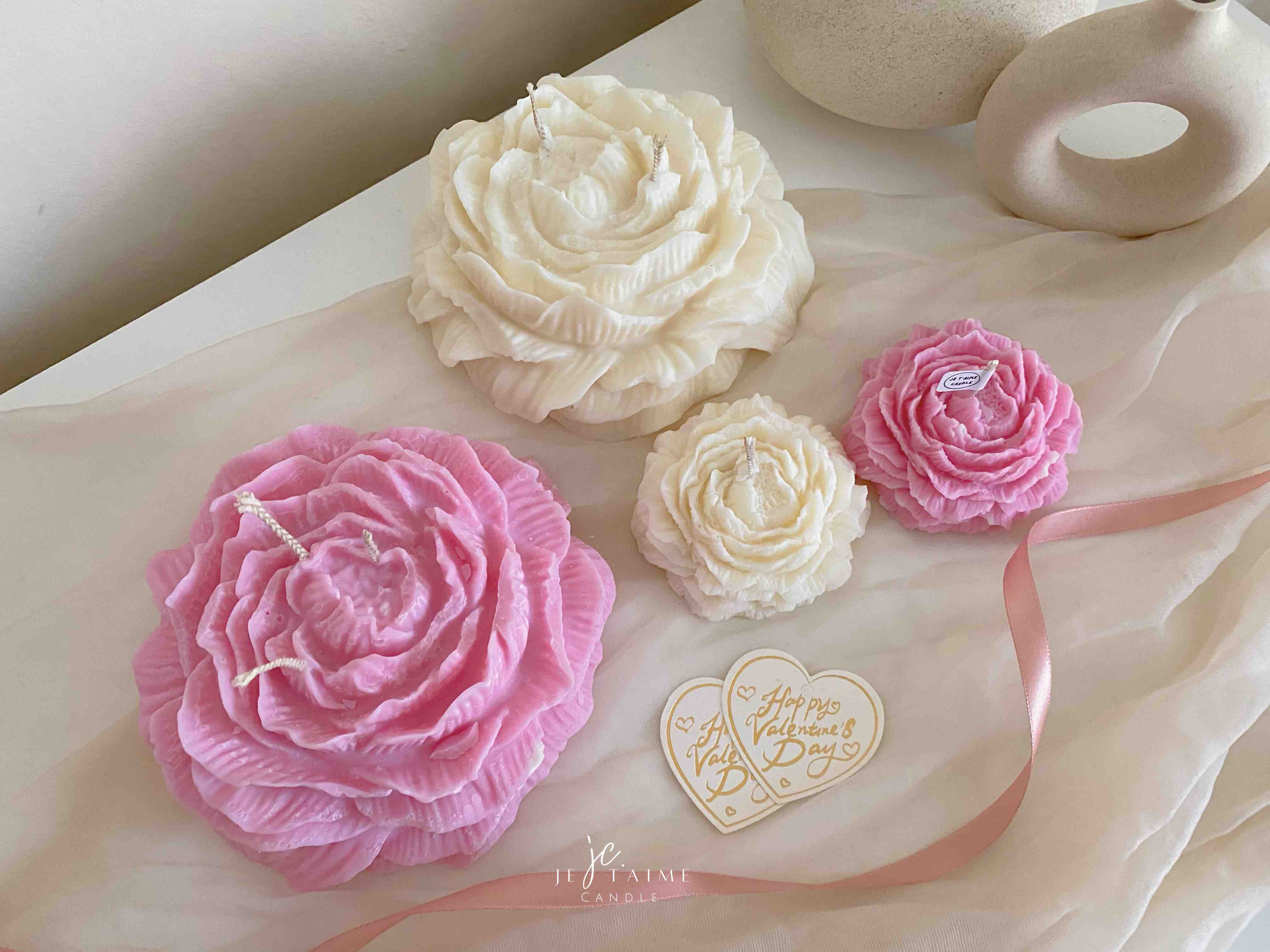 A table adorned with pink and white roses, creating a serene and elegant atmosphere for any occasion.