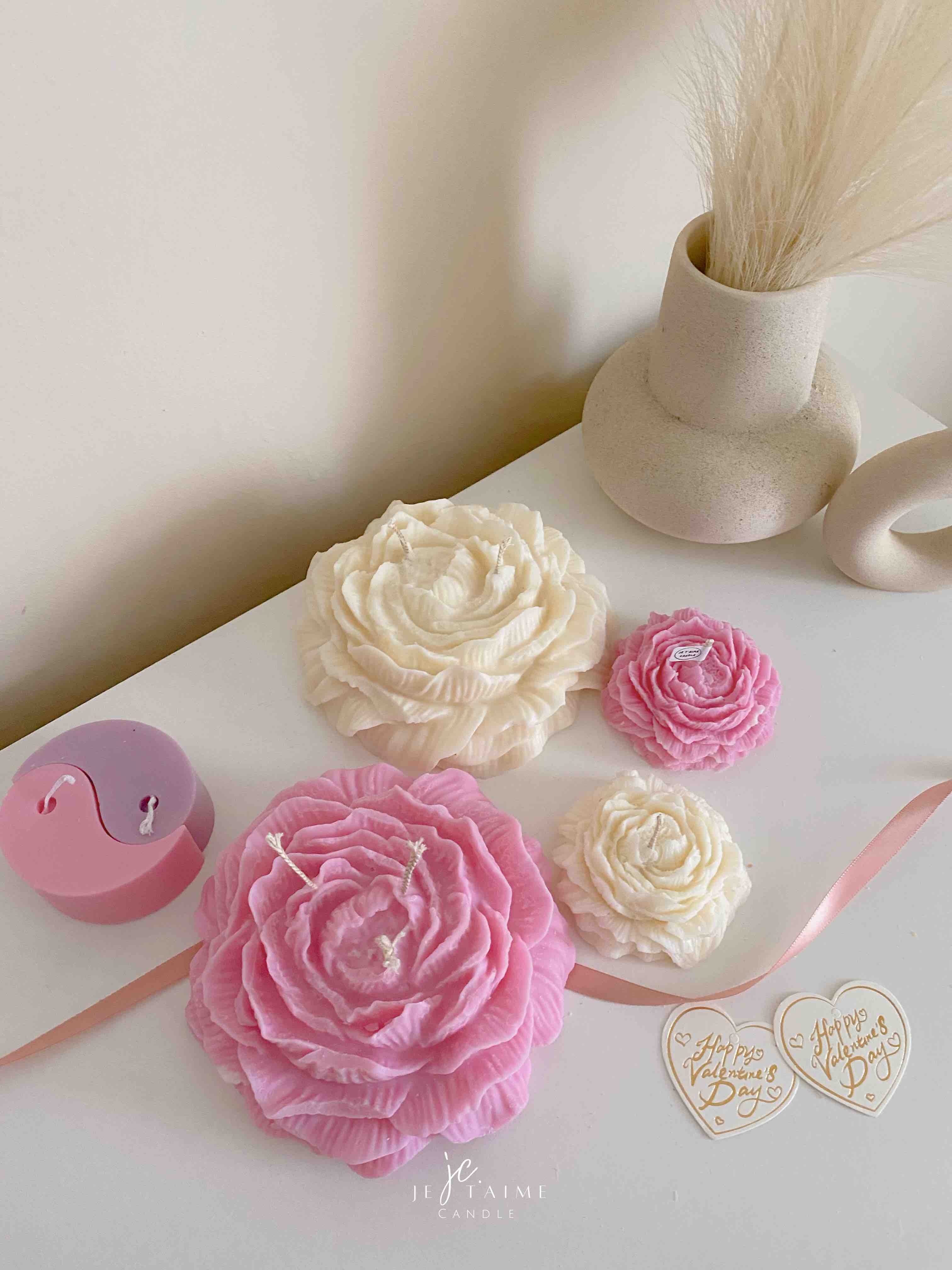 A table adorned with pink and white roses, creating a serene and elegant atmosphere for any occasion.