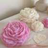 A table adorned with pink and white roses, creating a serene and elegant atmosphere for any occasion.