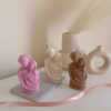Three beautifully designed candles in white, pink and brown, perfect for a romantic gift or anniversary celebration.