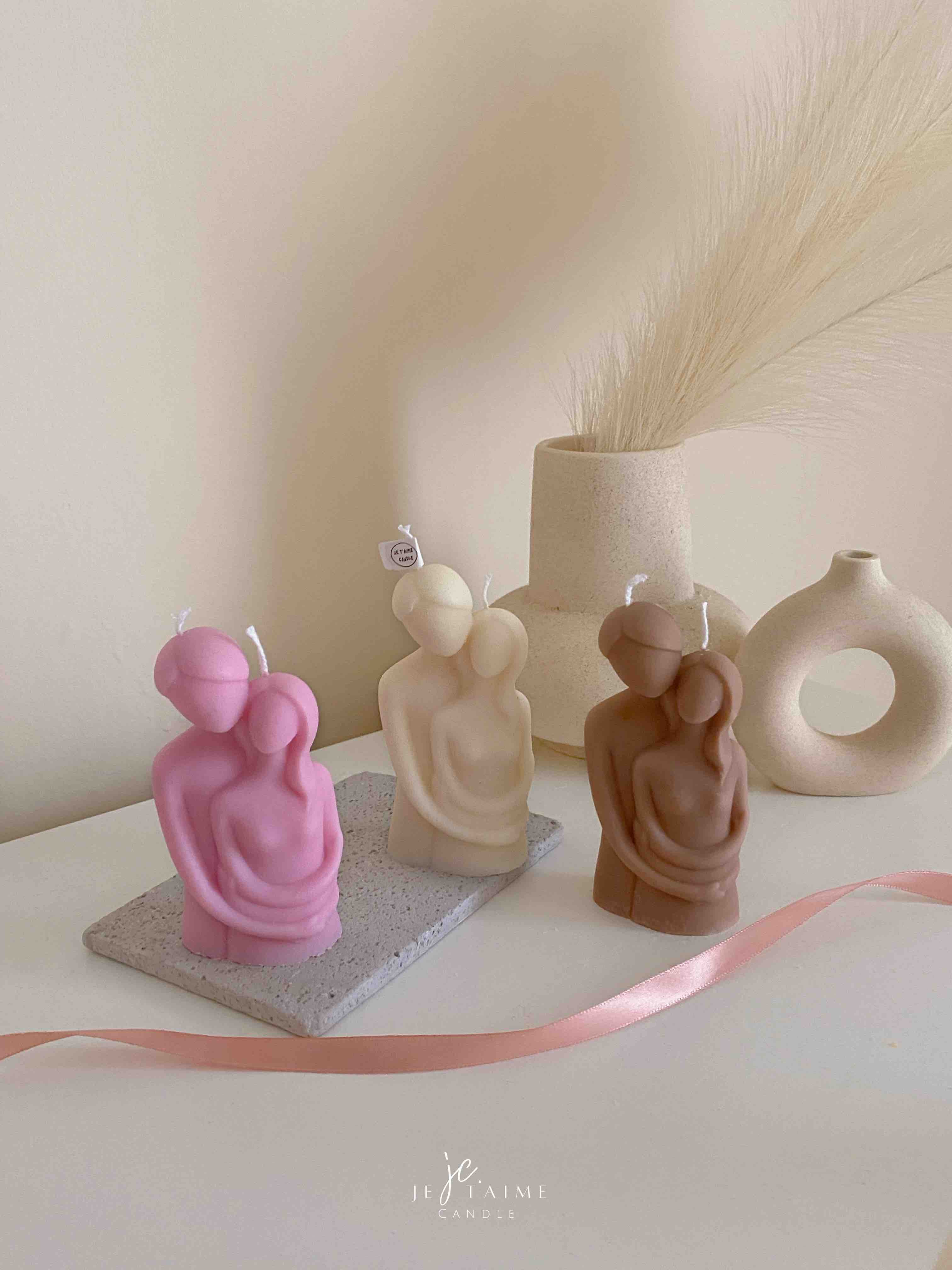 Three beautifully designed candles in white, pink and brown, perfect for a romantic gift or anniversary celebration.