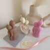 Three beautifully designed candles in white, pink and brown, perfect for a romantic gift or anniversary celebration.