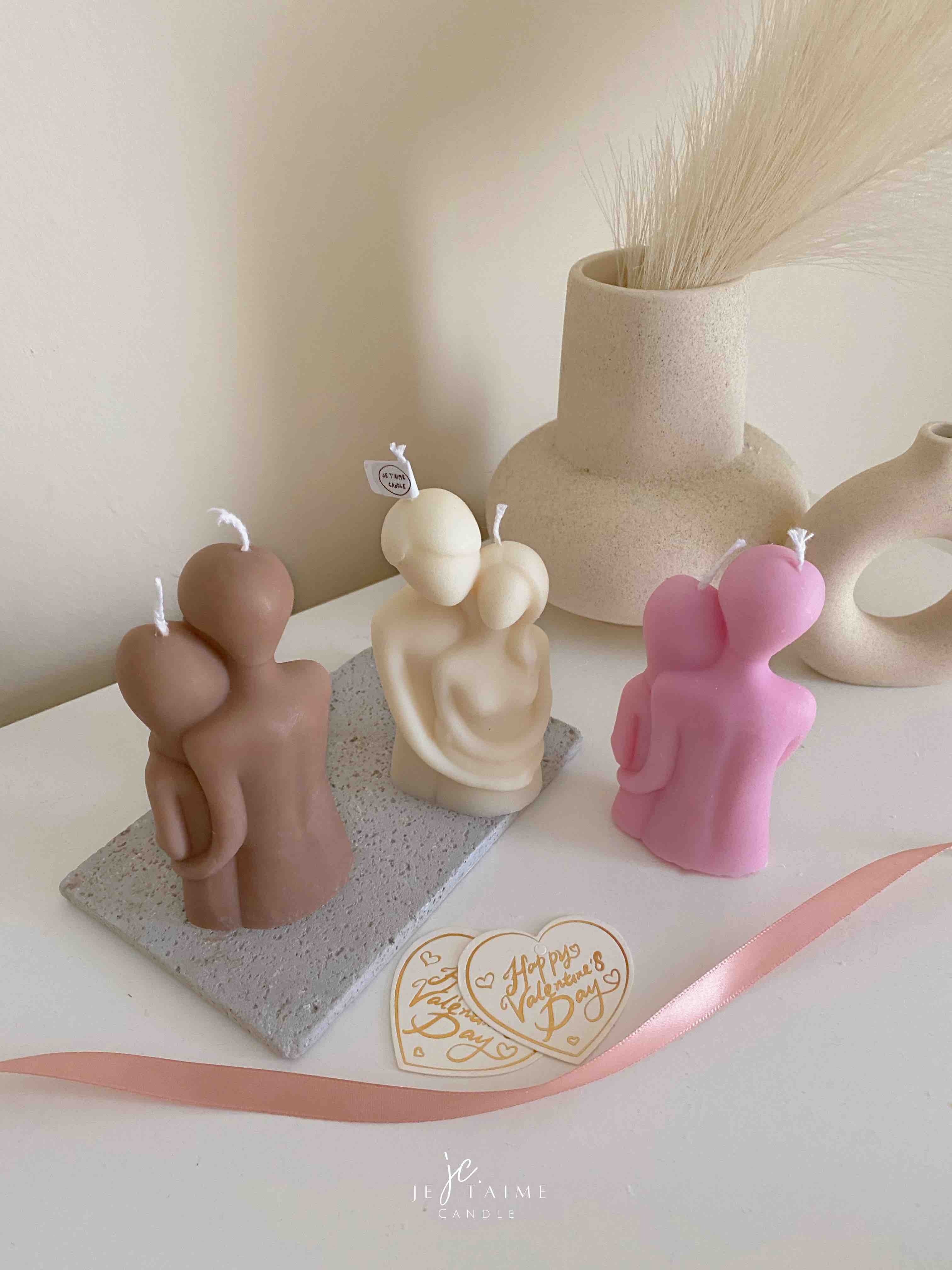 Three beautifully designed candles in white, pink and brown, perfect for a romantic gift or anniversary celebration.