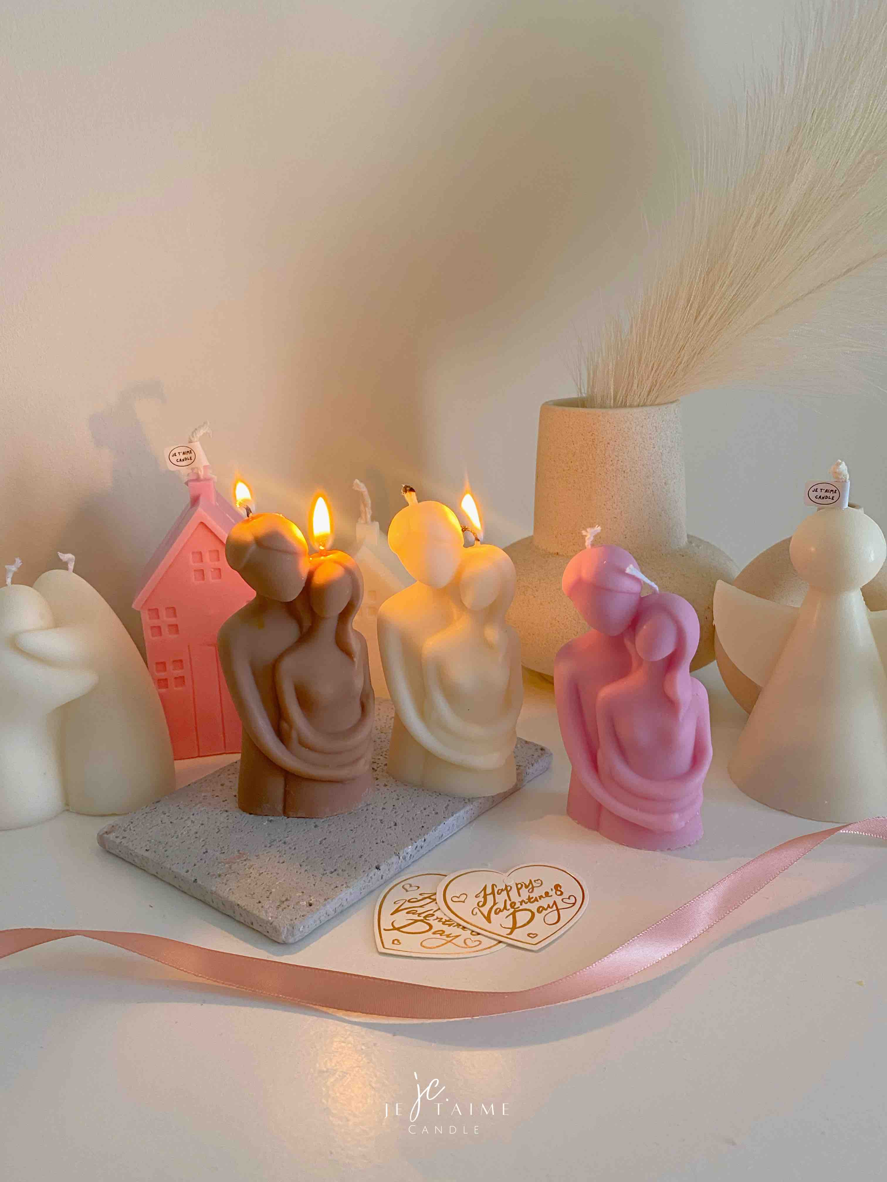 Three beautifully designed candles in white, pink and brown, perfect for a romantic gift or anniversary celebration.