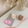 Three beautifully designed candles in white, pink and brown, perfect for a romantic gift or anniversary celebration.