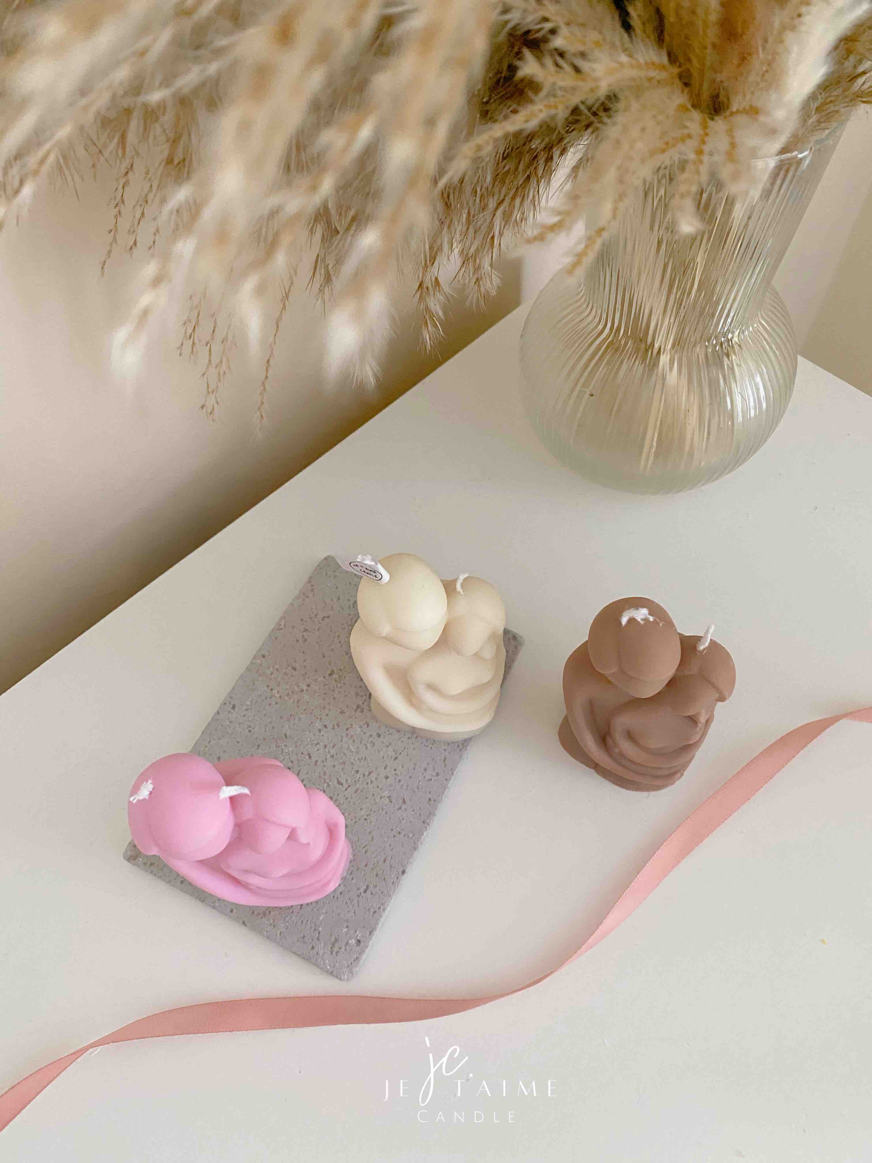 Three beautifully designed candles in white, pink and brown, perfect for a romantic gift or anniversary celebration.