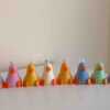 A row of cute, colorful duck candles lined up on a table, adding charm and whimsy to any space.