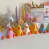A row of cute, colorful duck candles lined up on a table, adding charm and whimsy to any space.