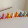 A row of cute, colorful duck candles lined up on a table, adding charm and whimsy to any space.