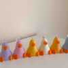 A row of cute, colorful duck candles lined up on a table, adding charm and whimsy to any space.