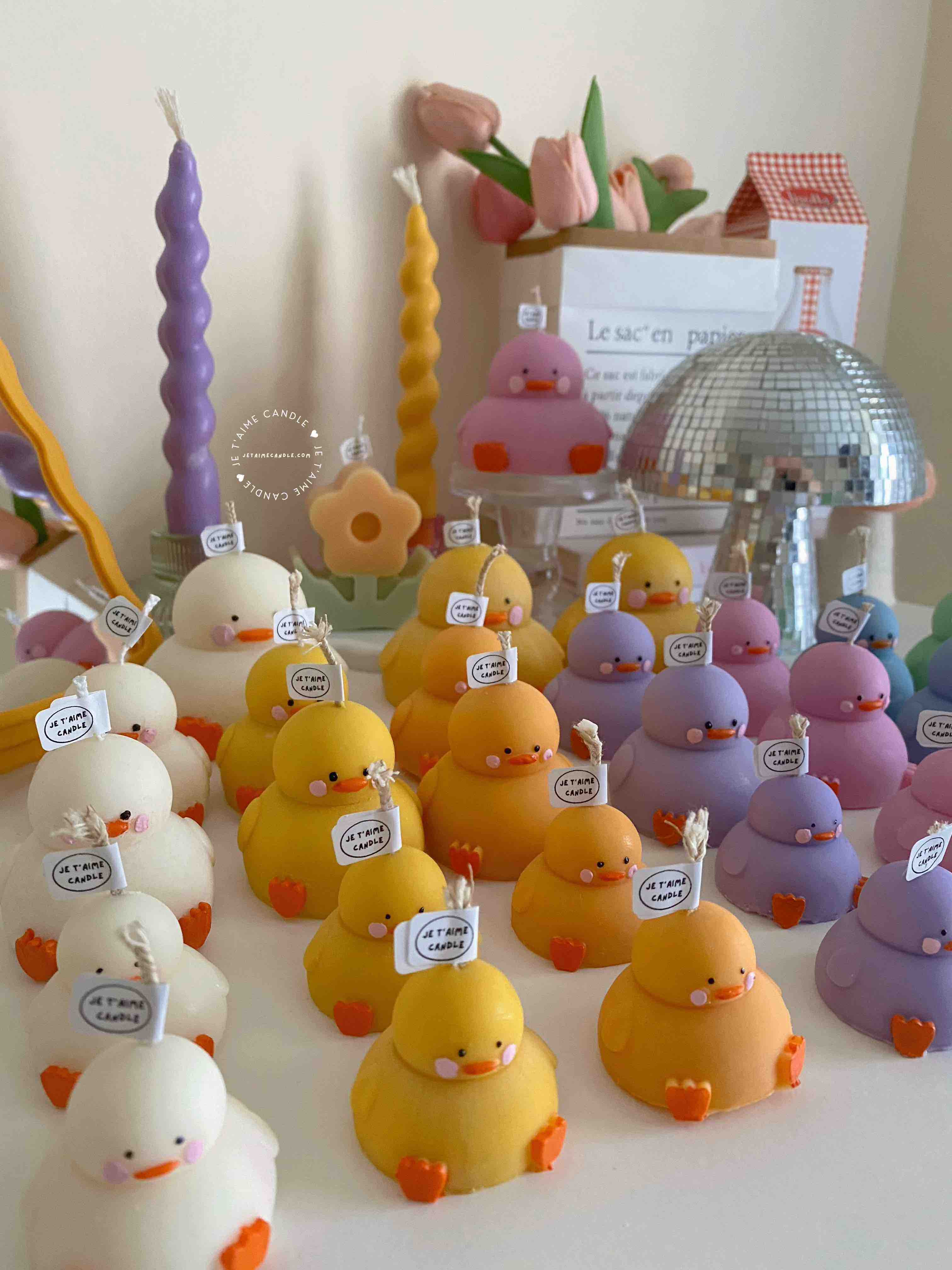 A collection of chubby duck-shaped candles on a table, perfect for duck lovers and quirky home decor enthusiasts.