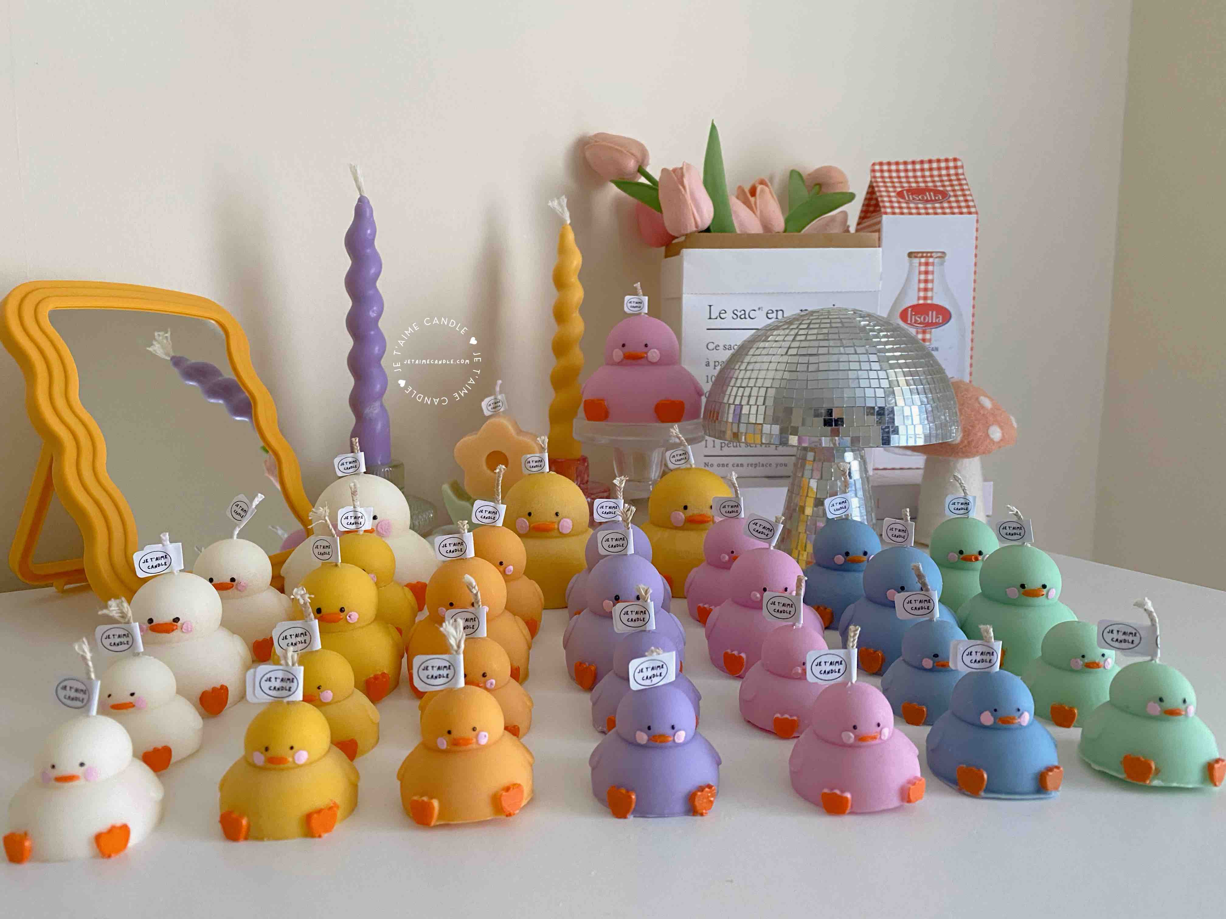 A collection of chubby duck-shaped candles on a table, perfect for duck lovers and quirky home decor enthusiasts.