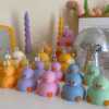 A collection of chubby duck-shaped candles on a table, perfect for duck lovers and quirky home decor enthusiasts.