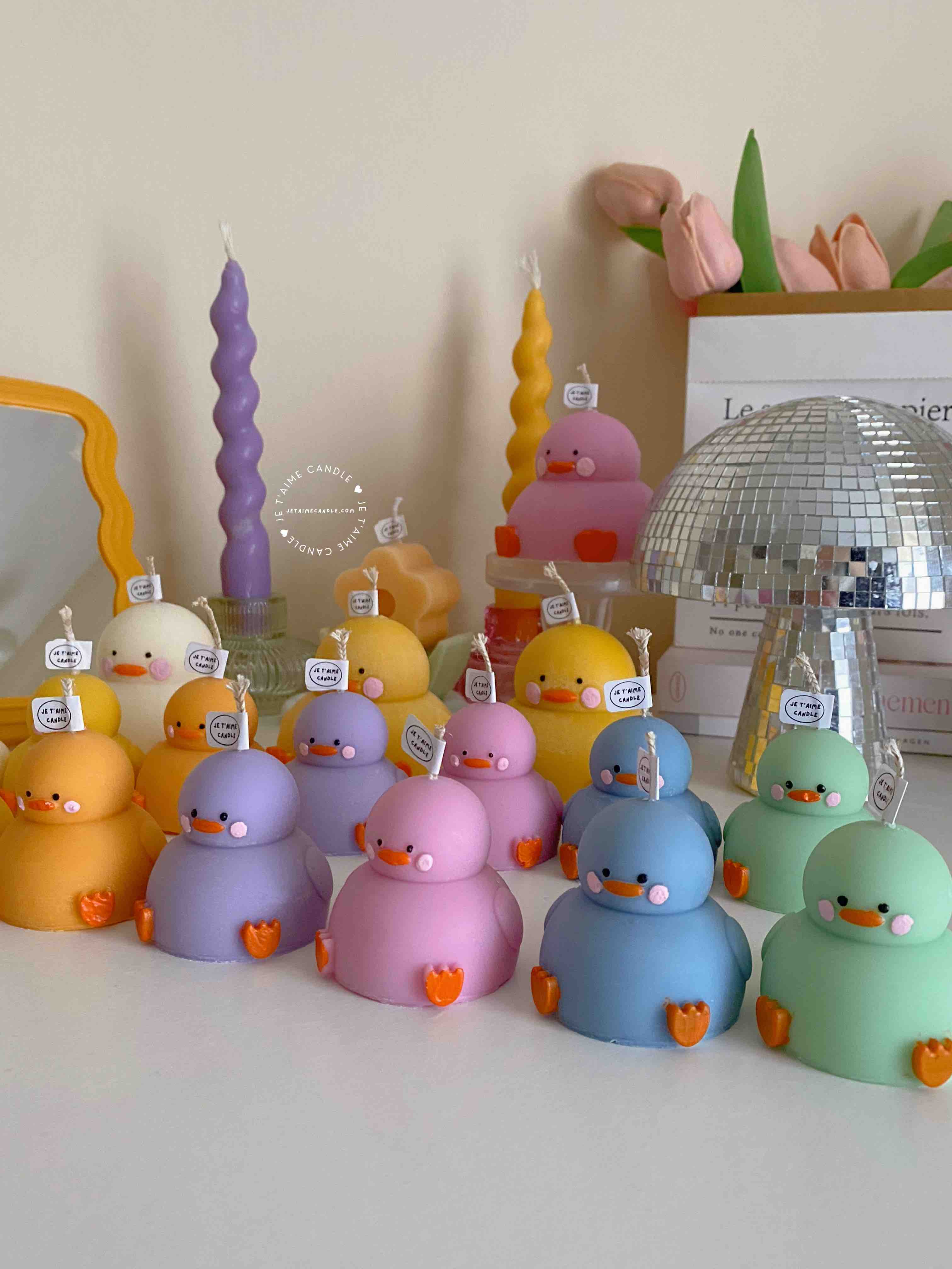 A collection of chubby duck-shaped candles on a table, perfect for duck lovers and quirky home decor enthusiasts.