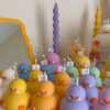 A collection of chubby duck-shaped candles on a table, perfect for duck lovers and quirky home decor enthusiasts.