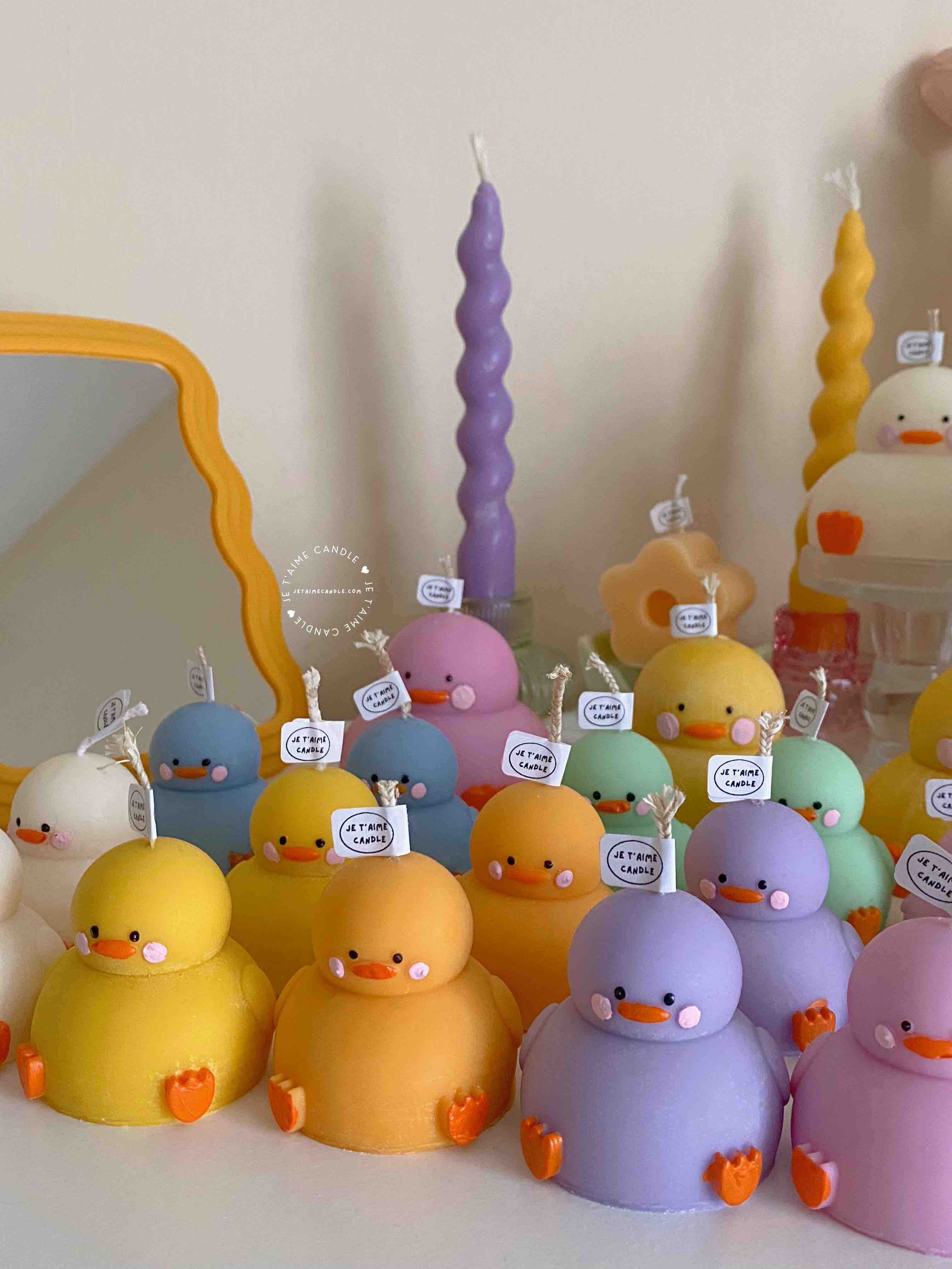 A collection of chubby duck-shaped candles on a table, perfect for duck lovers and quirky home decor enthusiasts.
