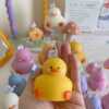A collection of chubby duck-shaped candles on a table, perfect for duck lovers and quirky home decor enthusiasts.