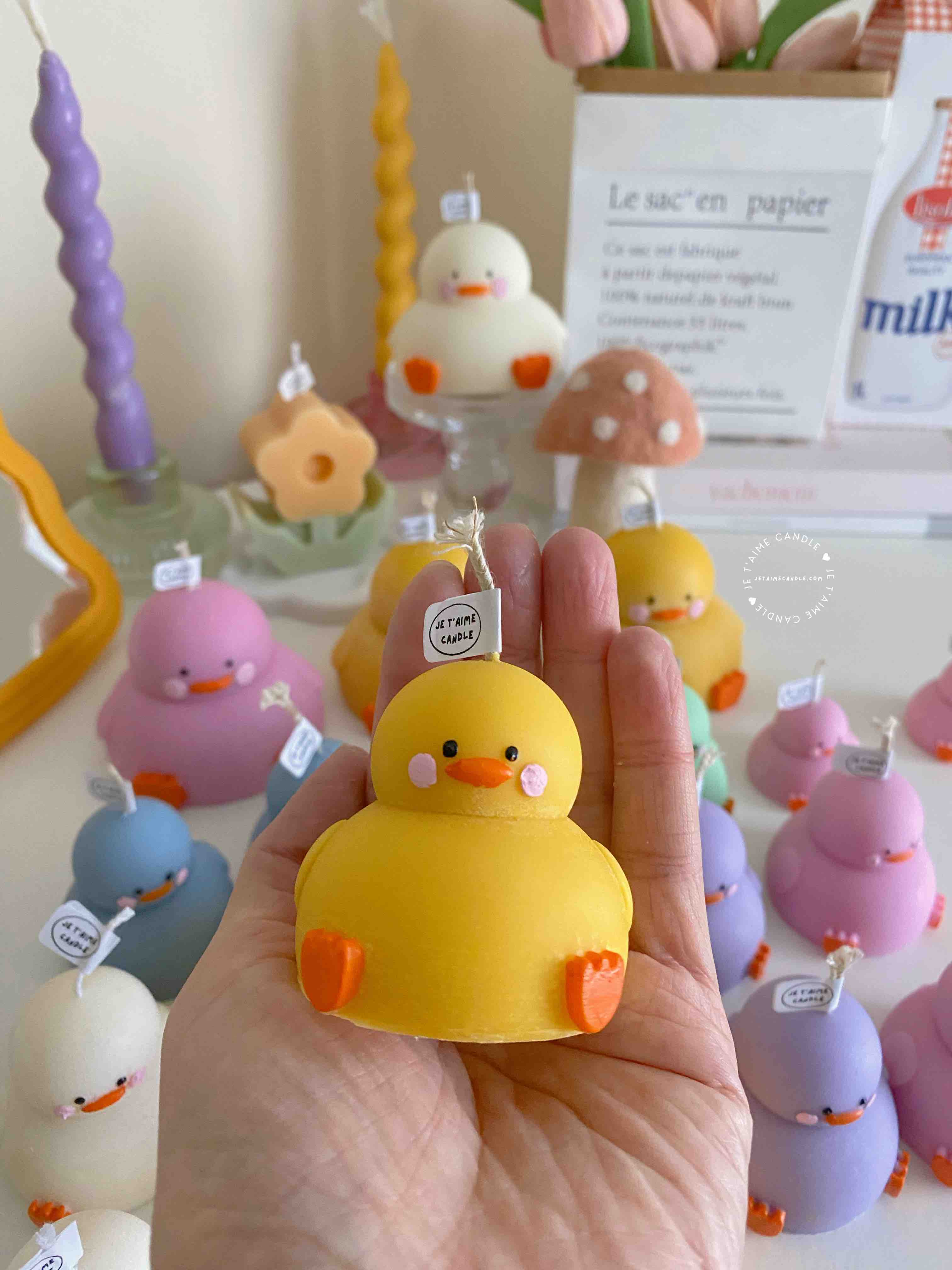 A collection of chubby duck-shaped candles on a table, perfect for duck lovers and quirky home decor enthusiasts.