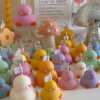 A collection of chubby duck-shaped candles on a table, perfect for duck lovers and quirky home decor enthusiasts.
