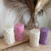 Four beautifully designed candles with floral and intricate patterns, adding elegance and warmth to any space.