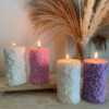 Four beautifully designed candles with floral and intricate patterns, adding elegance and warmth to any space.
