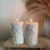 Two beautifully designed candles with floral and intricate patterns, adding elegance and warmth to any space.