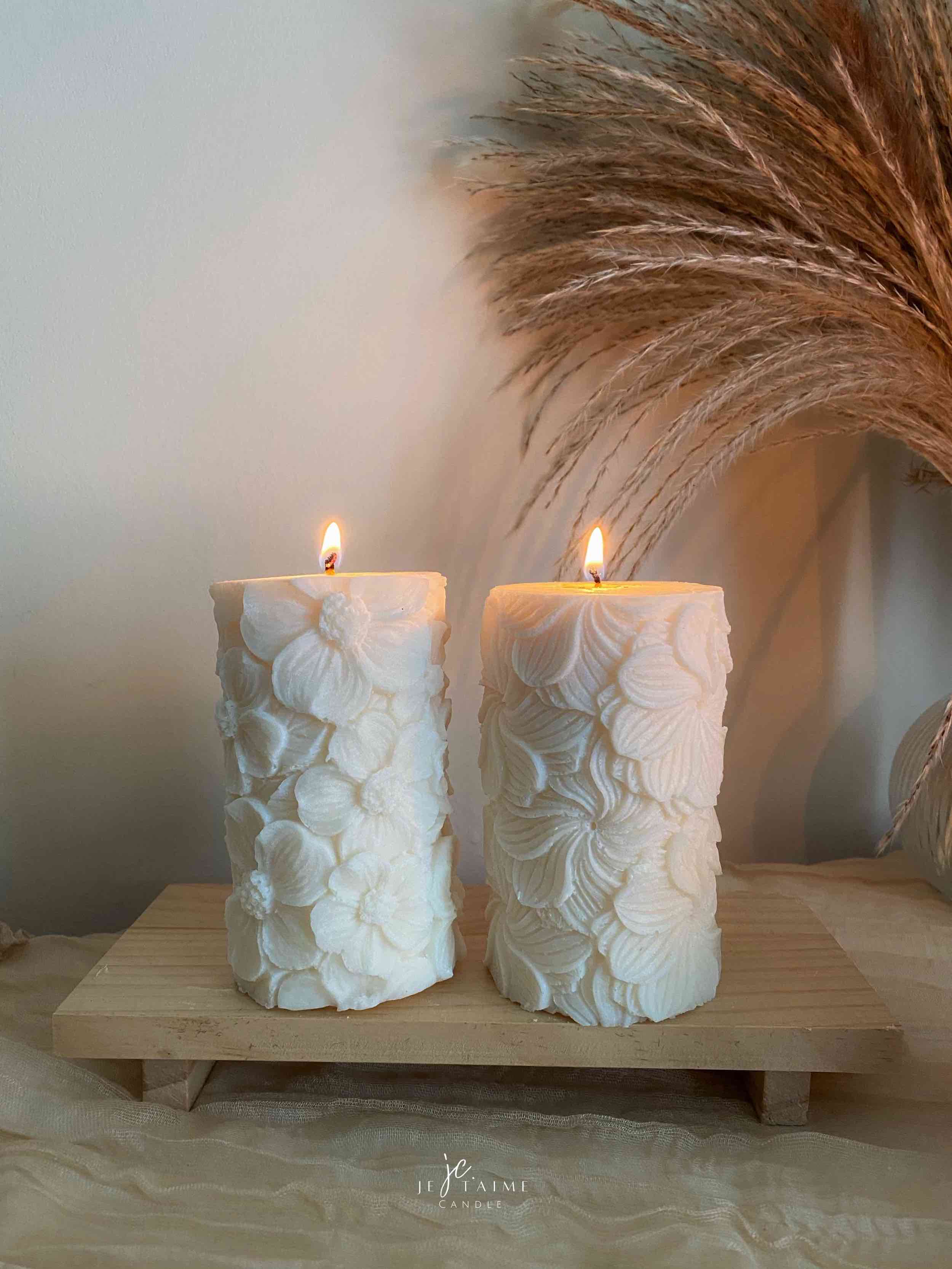 Two beautifully designed candles with floral and intricate patterns, adding elegance and warmth to any space.