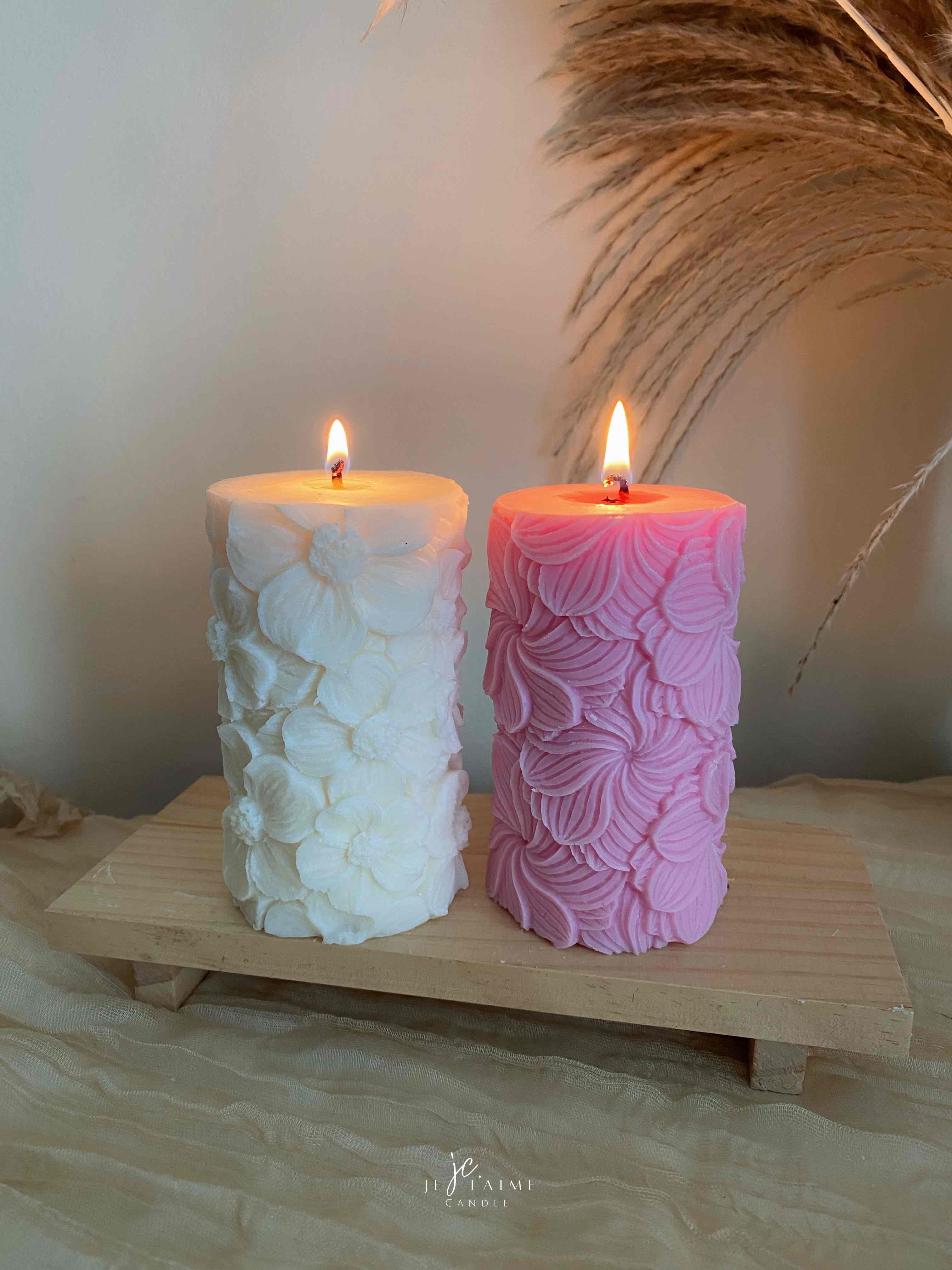 Two beautifully designed candles with floral and intricate patterns, adding elegance and warmth to any space.