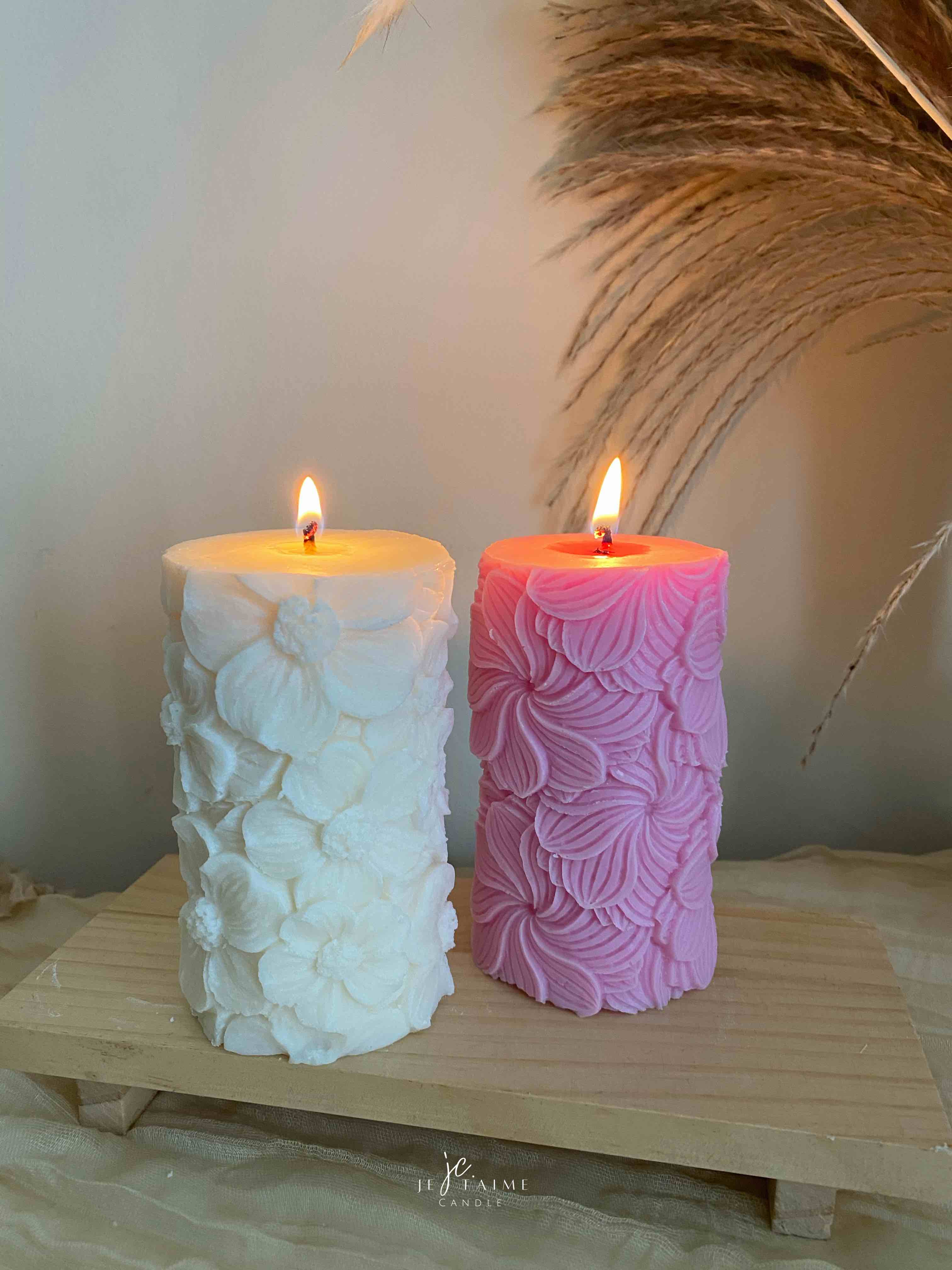 Two beautifully designed candles with floral and intricate patterns, adding elegance and warmth to any space.