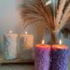 A tall handmade pillar candle featuring a delicate floral embossed pattern, crafted from soy wax in an elegant design. The candle stands upright on a neutral-toned background, highlighting its textured botanical details. Perfect as a decorative candle for weddings, home décor, or special occasions, this floral relief pillar candle adds sophistication, warmth, and charm to any setting. Ideal as a gift for candle lovers, rustic décor accent, or centerpiece decoration.