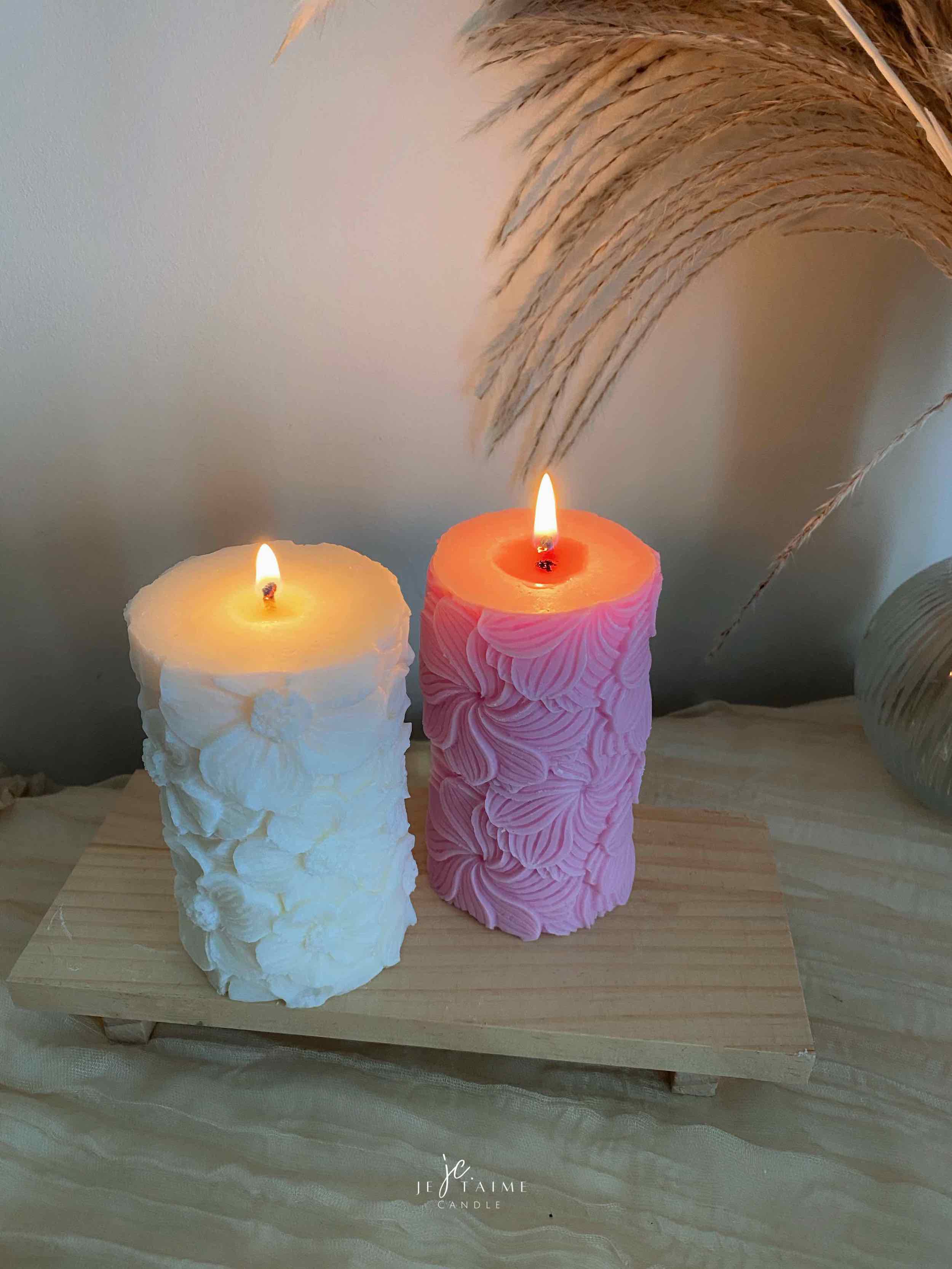 Four beautifully designed candles with floral and intricate patterns, adding elegance and warmth to any space.