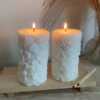 Two beautifully designed candles with floral and intricate patterns, adding elegance and warmth to any space.