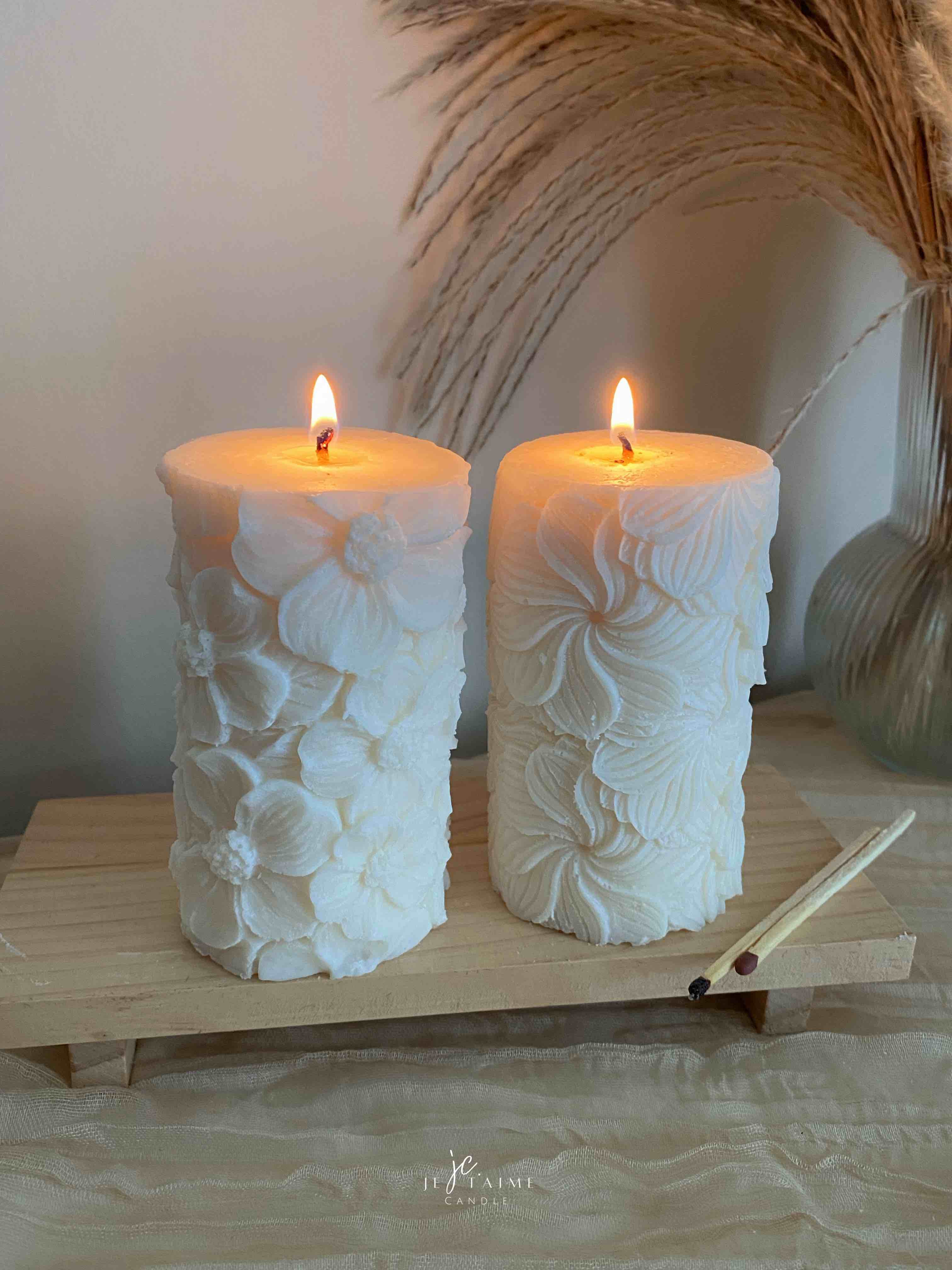 Two beautifully designed candles with floral and intricate patterns, adding elegance and warmth to any space.