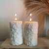 Two beautifully designed candles with floral and intricate patterns, adding elegance and warmth to any space.
