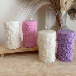 A tall handmade pillar candle featuring a delicate floral embossed pattern, crafted from soy wax in an elegant design. The candle stands upright on a neutral-toned background, highlighting its textured botanical details. Perfect as a decorative candle for weddings, home décor, or special occasions, this floral relief pillar candle adds sophistication, warmth, and charm to any setting. Ideal as a gift for candle lovers, rustic décor accent, or centerpiece decoration.