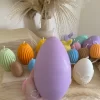 A cheerful assortment of colorful egg candles on a table, perfect for celebrating a joyful occasion.